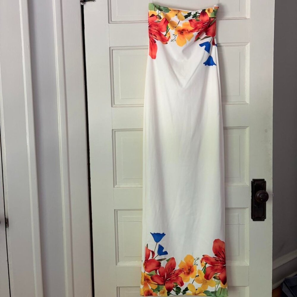 White maxi strapless floral print dress with blue, orange, and yellow hues